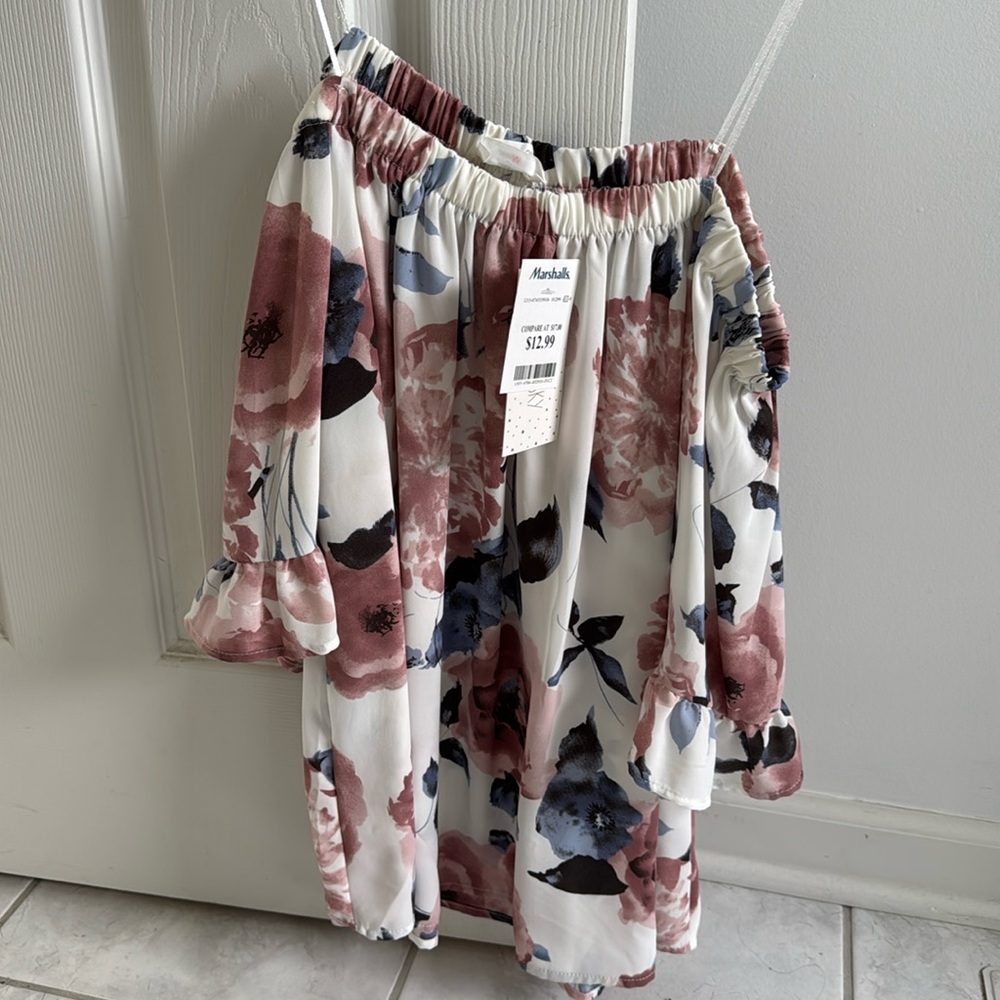 Size medium floral loose over the shoulder top. Never worn with tags!